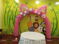 Unicorn Balloon arch for a 3rd birthday made of pink and white balloons complete with ears and a horn. The mane of the Unicorn is made using colourful tube balloons. 